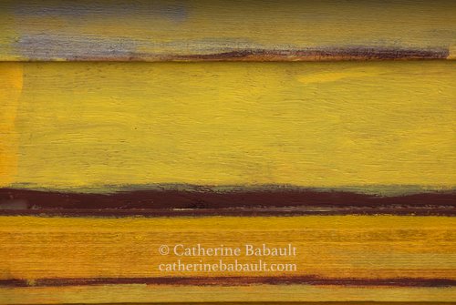 abstract photography of a yellow and brown wooden siding on an old building by Catherine Babault